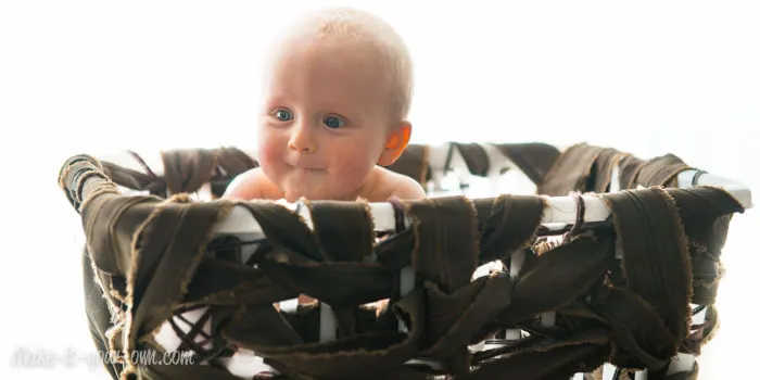 Baby in a Large Bird's Nest Storage Basket