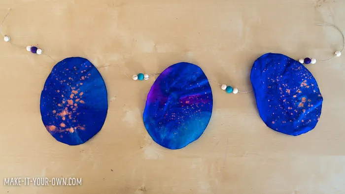 Children in Preschool, Kindergarten and School age will enjoy this painting activity which incorporates pipette painting and splatter painting to make an EASTER EGG GARLAND that would make a beautiful sun catcher!